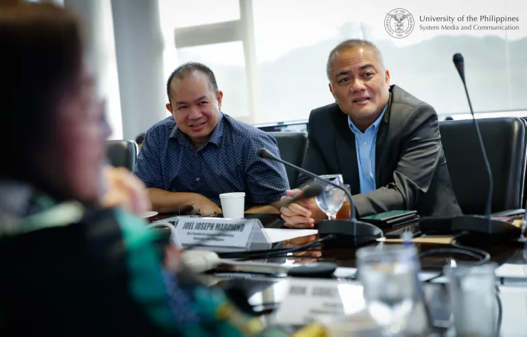 UP Assistant Vice President for Academic Affairs Percival Almoro (left) and Vice President for Research and Innovation Joel Joseph Marciano (right), listen to Guinto-Sali’s message. Photo by Misael Bacani, UPS-MCO.